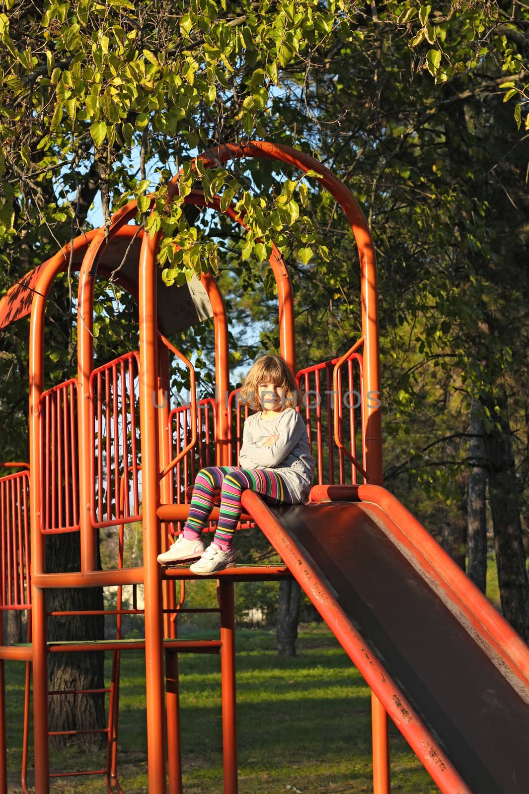 little girl on playground slide