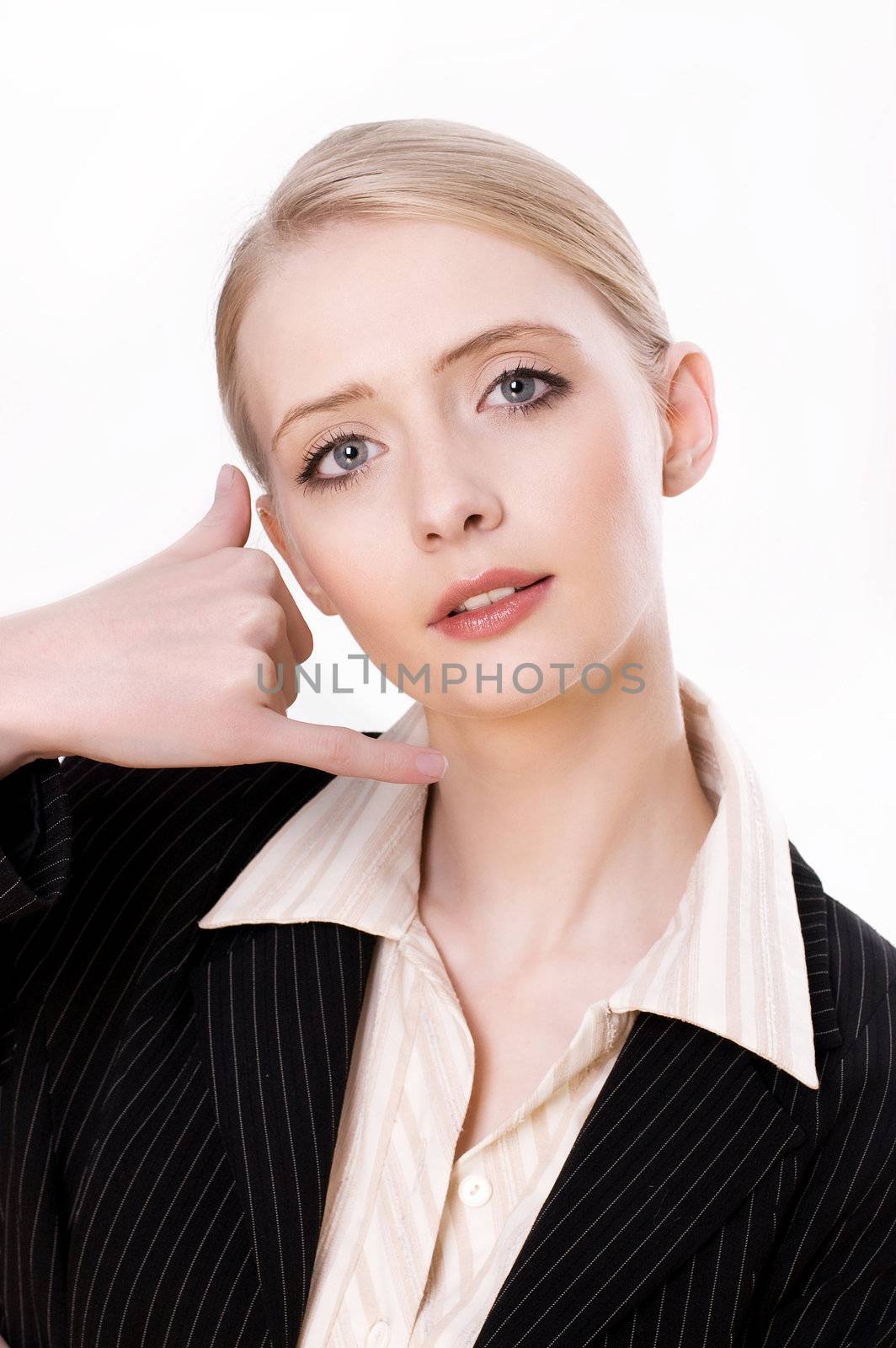 Portrait of a young business woman gesturing a call me sign against white background 