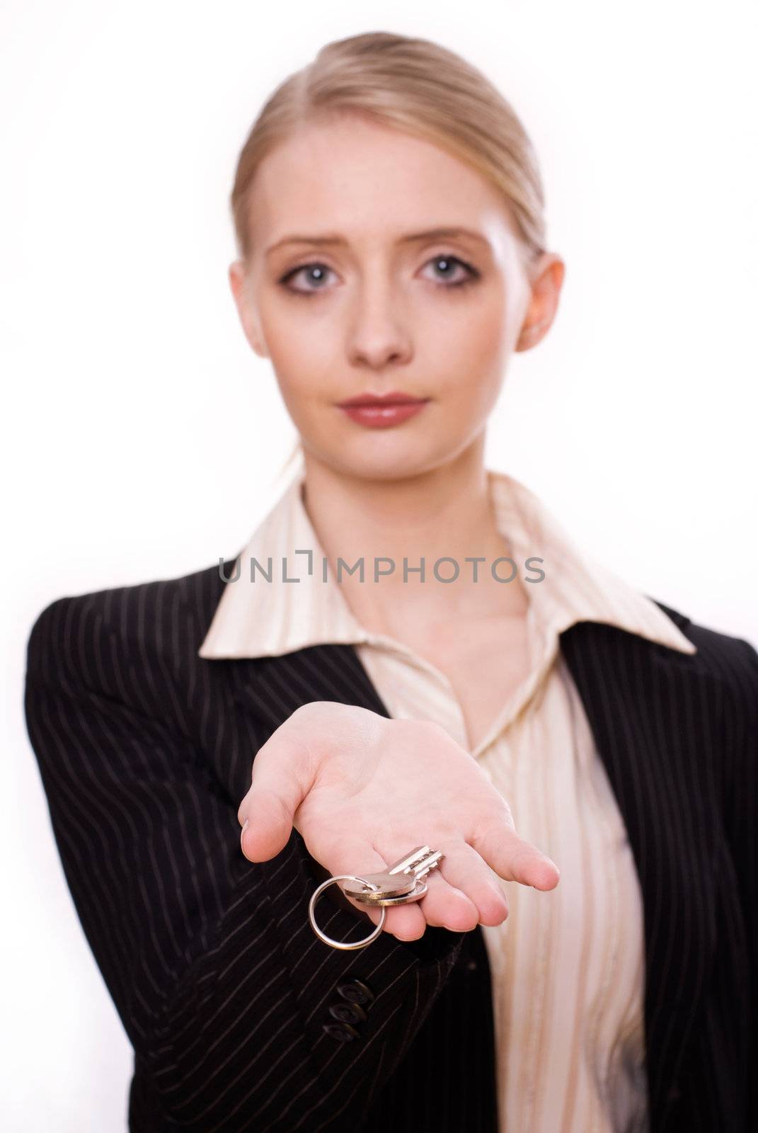 Photo of woman's hand holding a new key and pointing it at the camera