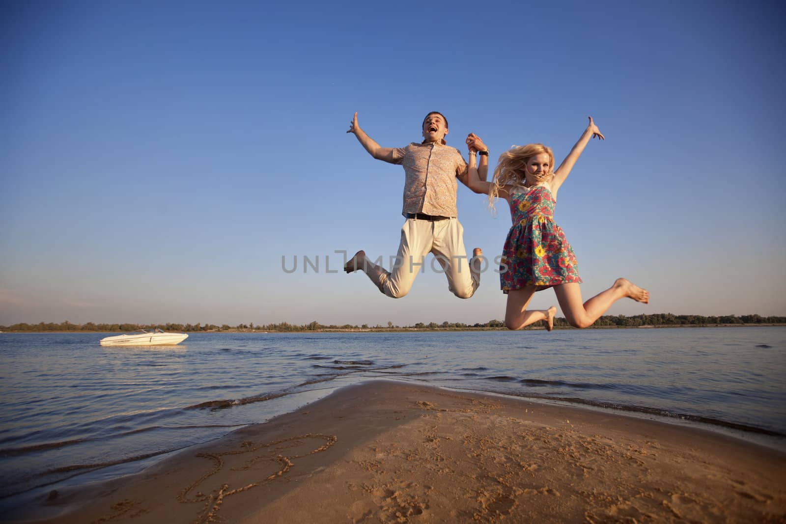 couple jumping on the beach by vsurkov