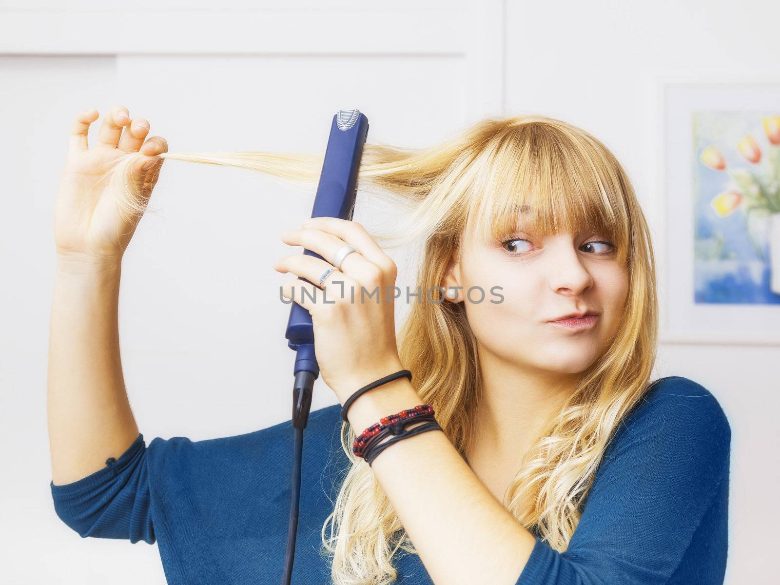 An image of a beautiful teenage girl smooting her hair