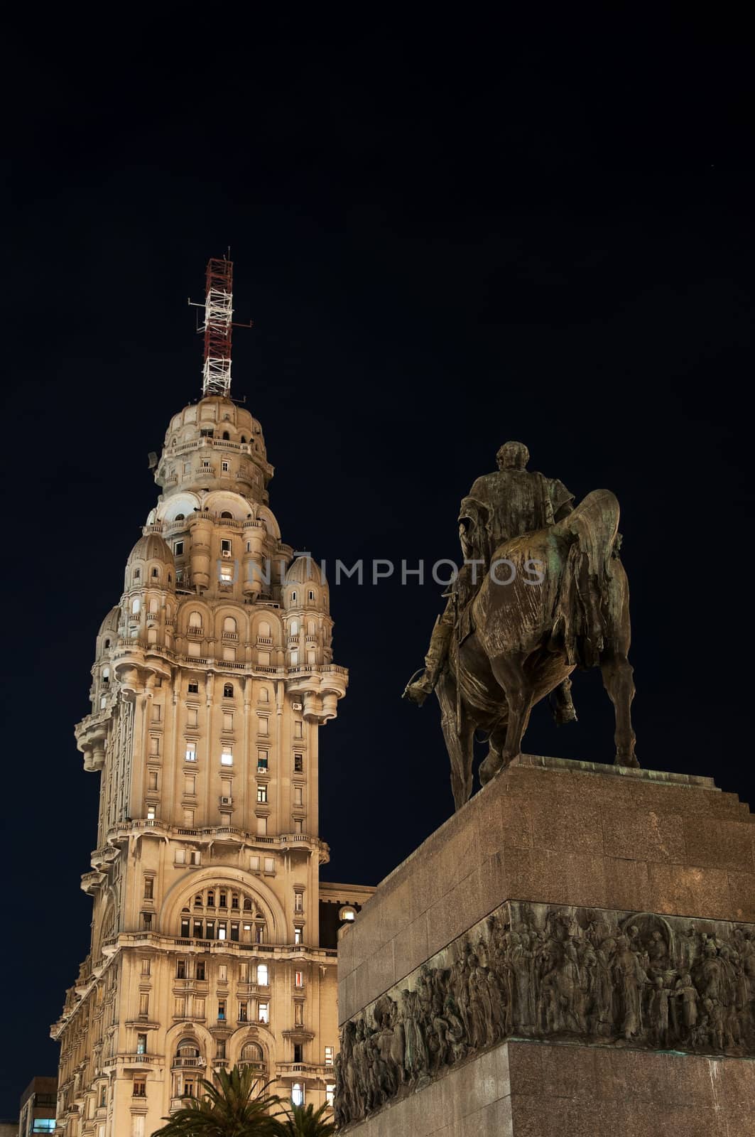 Public statue of General Artigas and towering skyscraper in Montevideo at night