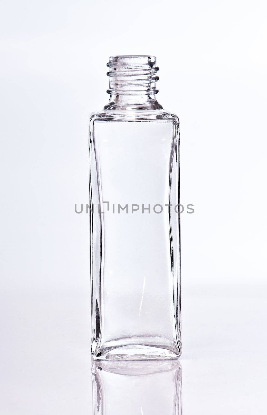 empty glass perfume bottle on a light backgroung