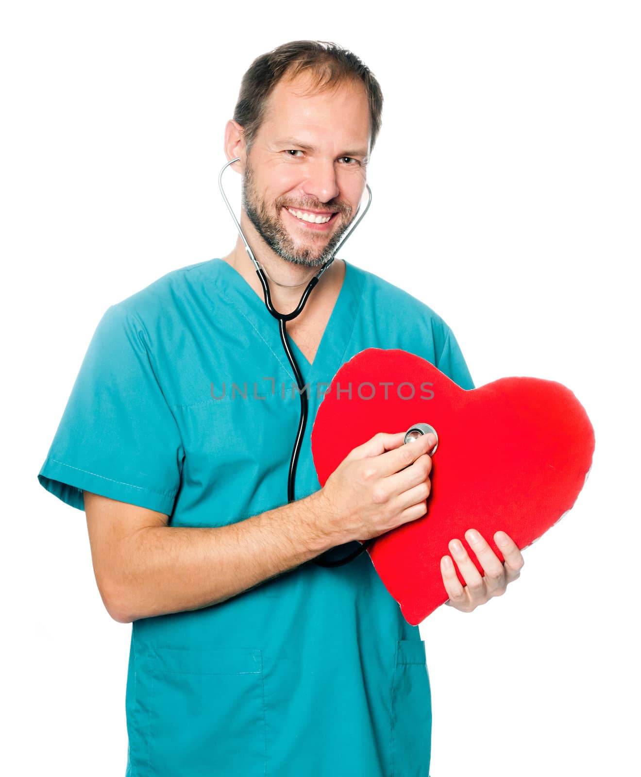 A male doctor examining a red heart shaped pillow with a stethoscope against white background