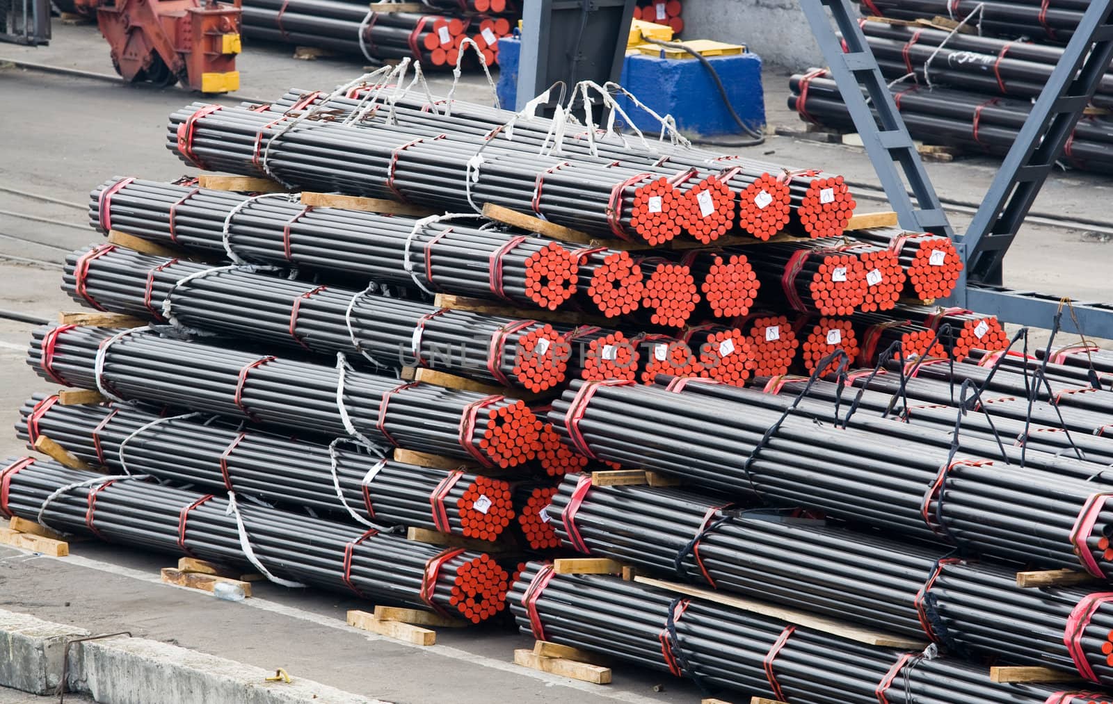 Stack of metal rods prepared for shipment on industrial area