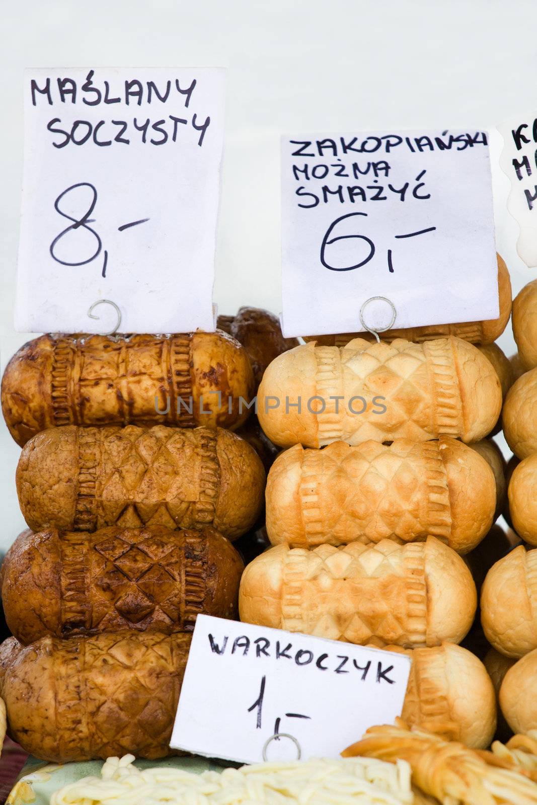 Homemade smoked polish cheese oscypki close-up on the craft market counter in Zakopane