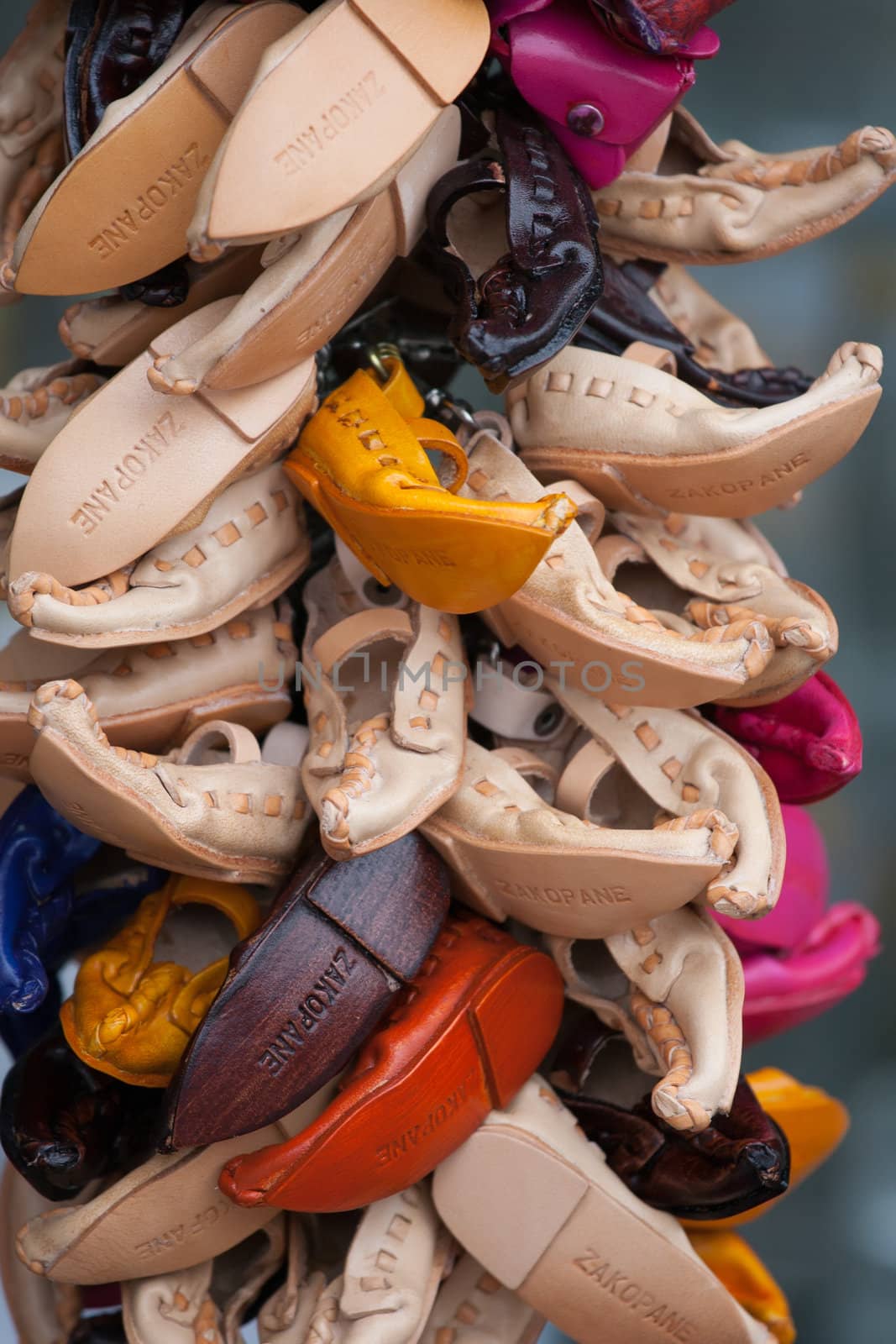 Bundle of small tourists vintage souvenirs multicolored decorative handmade leather shoes with pointed toes close-up on craft market in Zakopane Poland