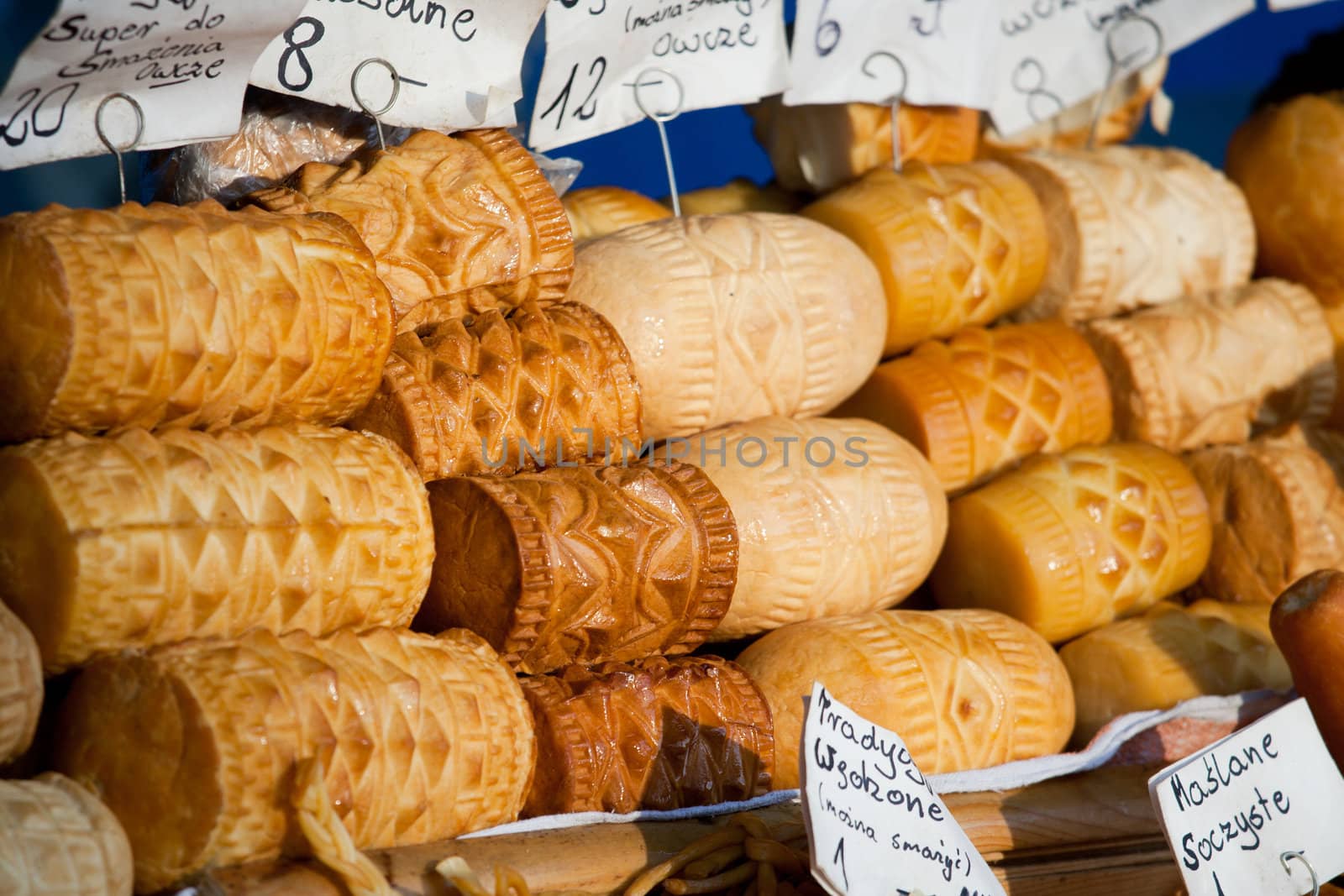 Homemade smoked polish cheese oscypki close-up on the craft market counter in Zakopane