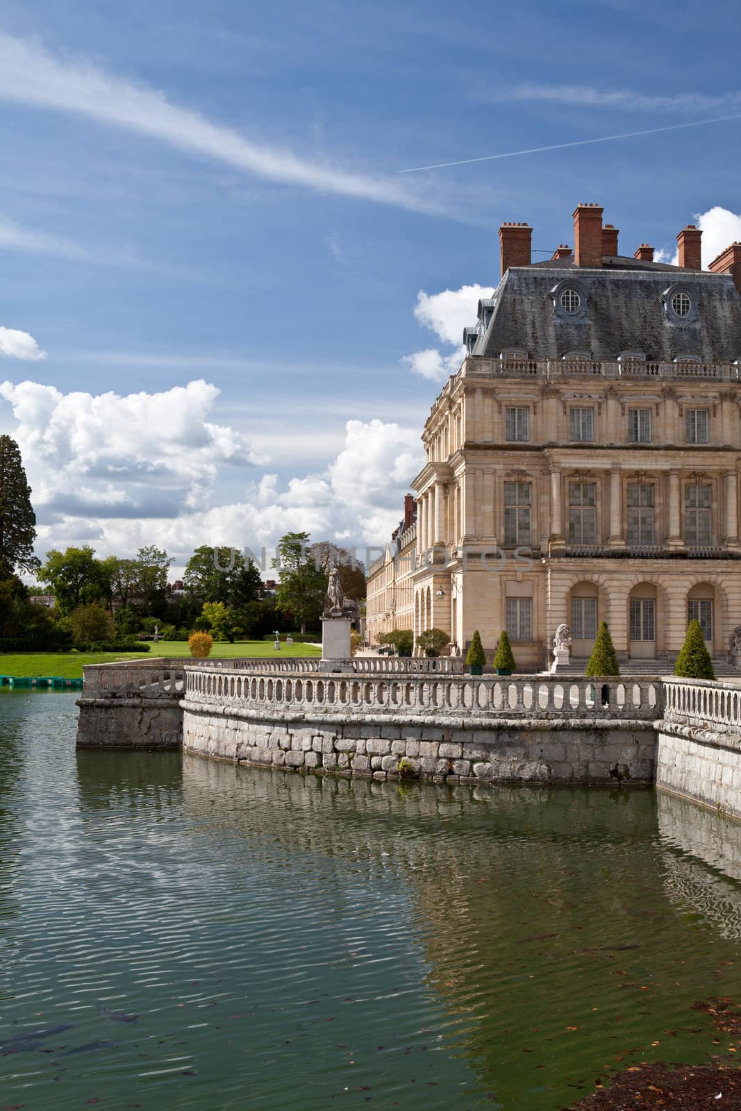 Medieval landmark royal hunting castle Fontainbleau near Paris in France and lake