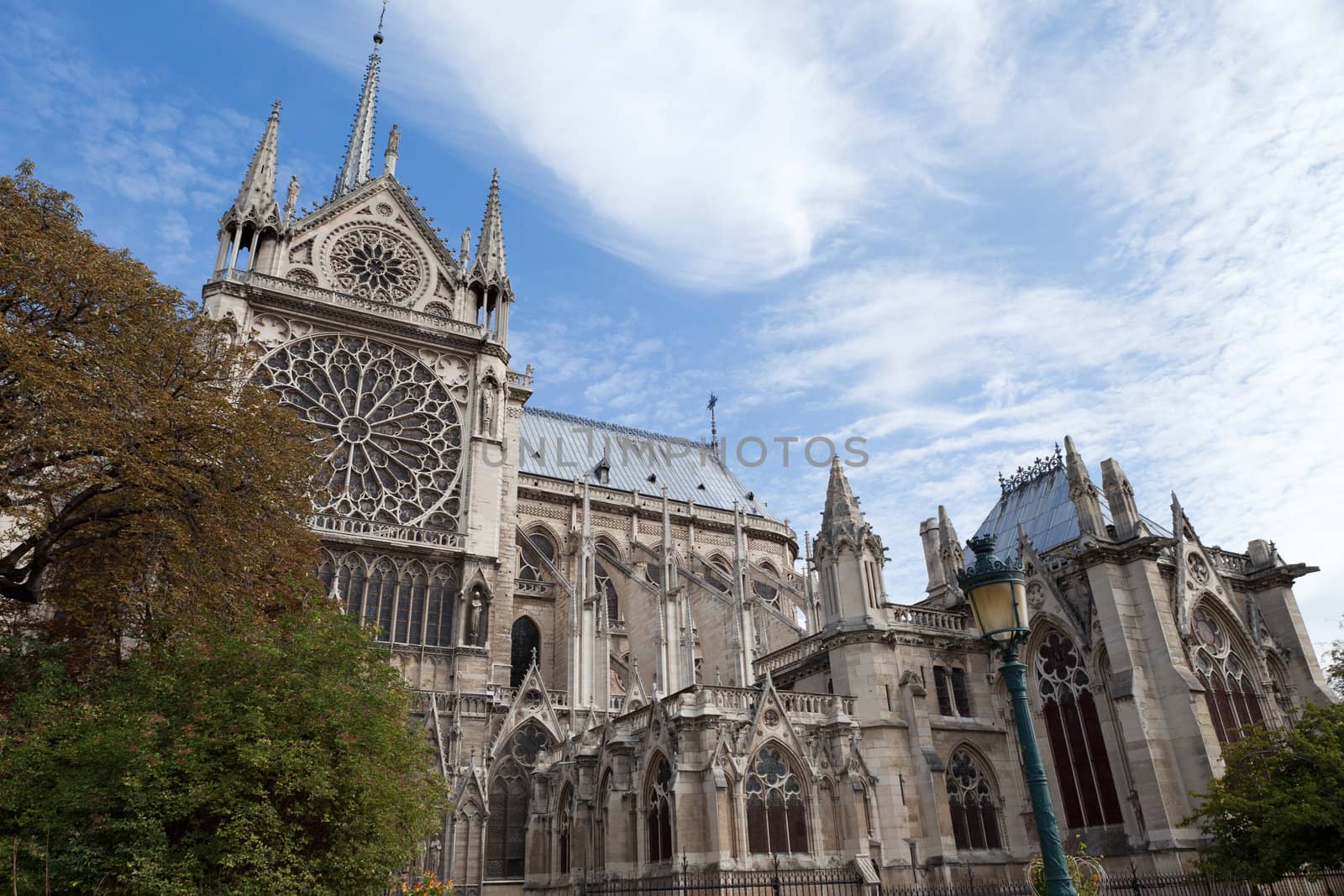 Famous landmark Gothic catholic cathedral Notre-dame on Cite island in Paris France on the blue and cloudy sky background