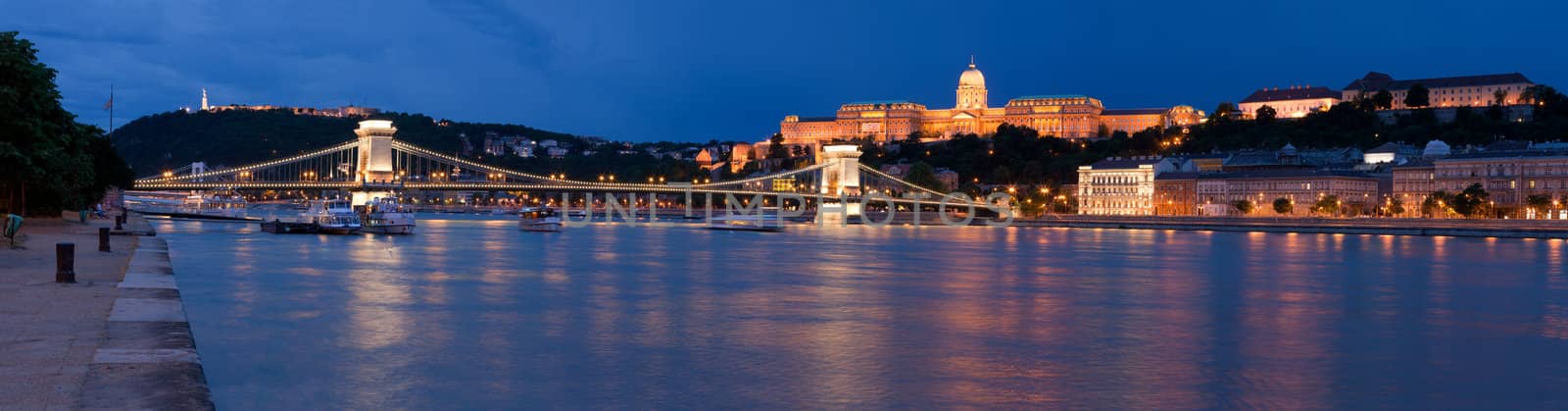 Panoramic night cityscape on landmark Gellert and castle hill Buda, baroque royal palace, Szechenyi chain bridge over Danube river in twilight Budapest Hungary