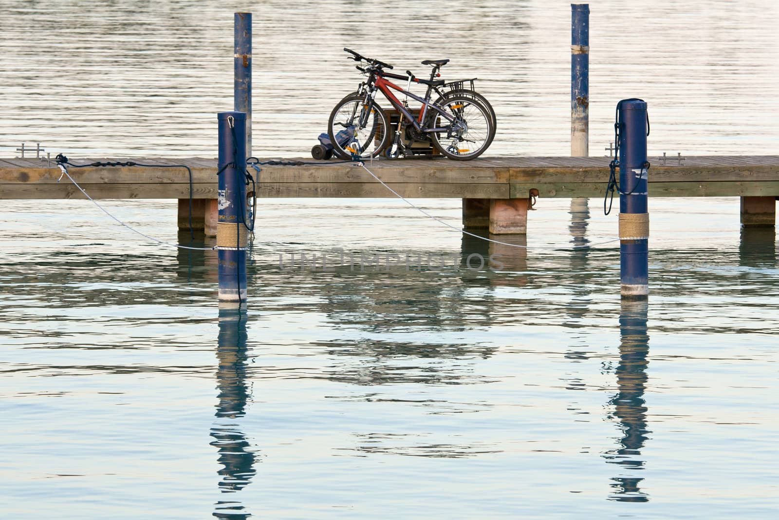 Bicycles are left on the lake bridge. Tranquil scene