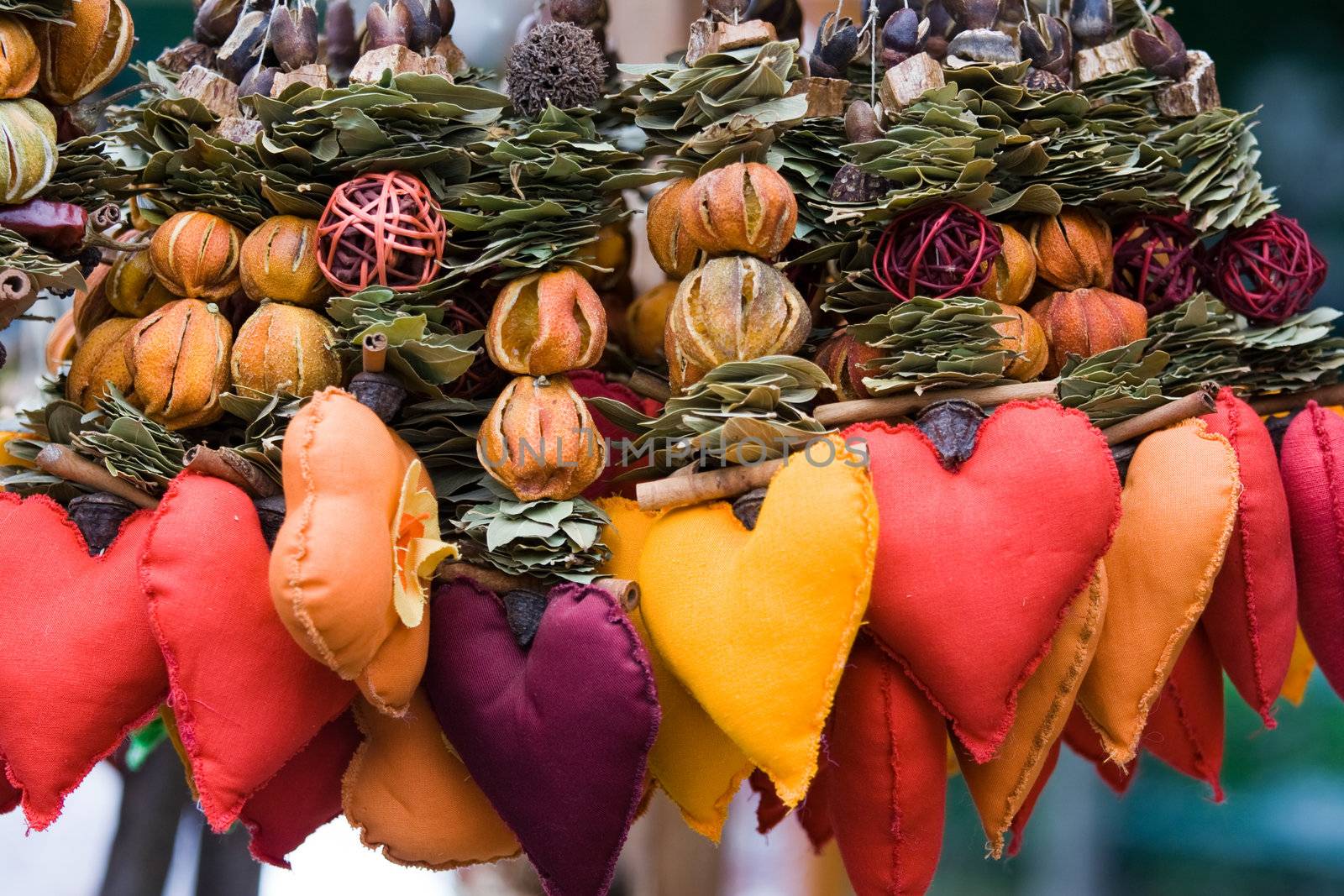 Handicraft decor, souvenir for Valentine’s day.  Strings of dried leaves, fruits and cloth hearts