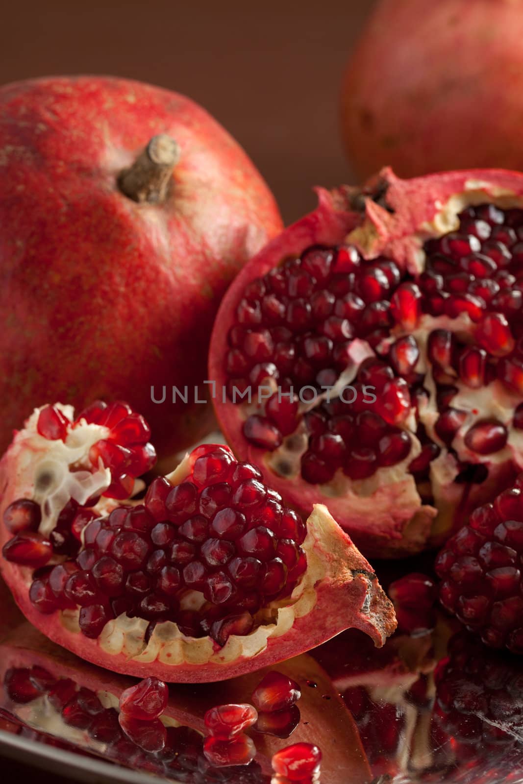 Pomegranate slices and seeds on silver salver