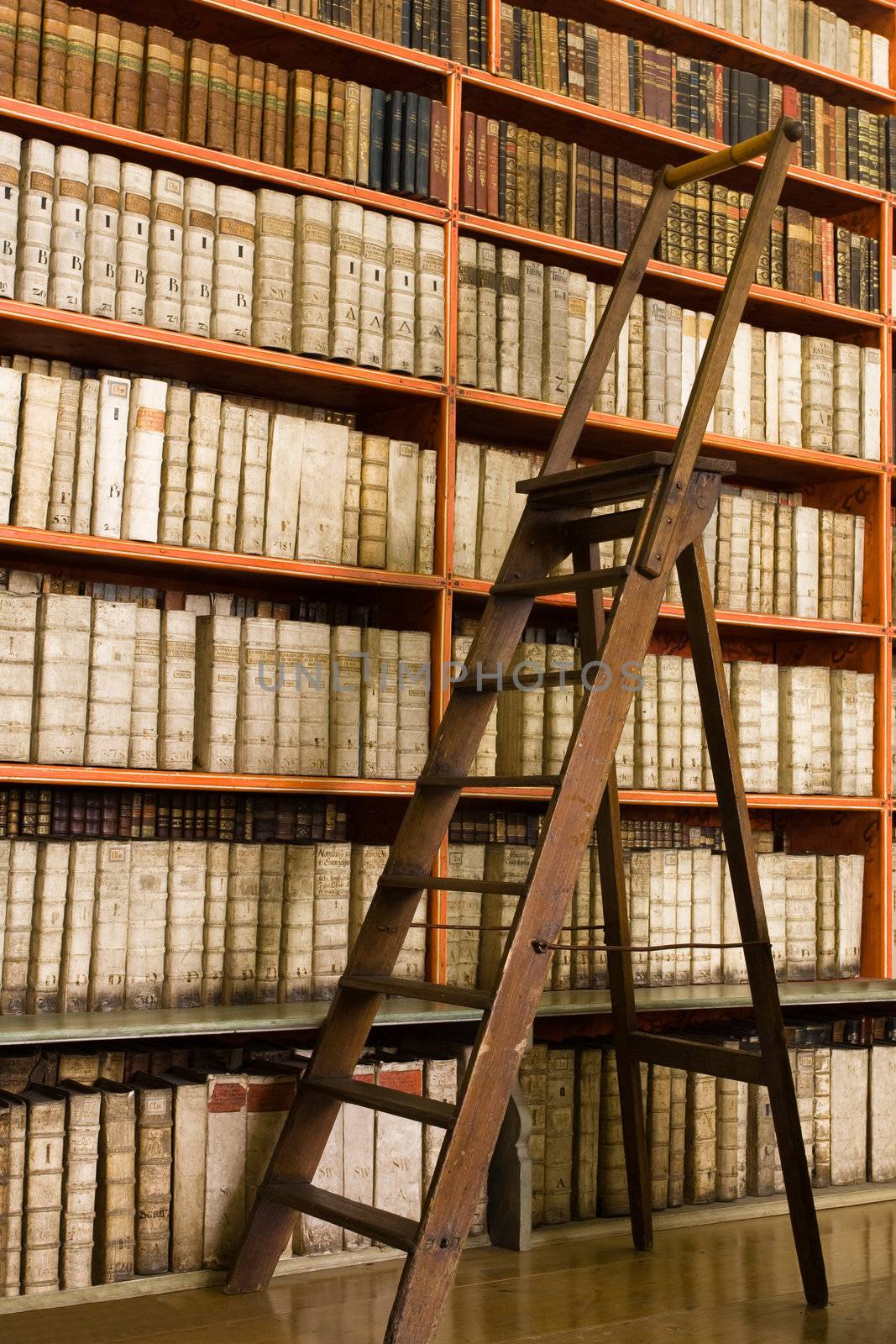 Library with aged books and ladder on the floor