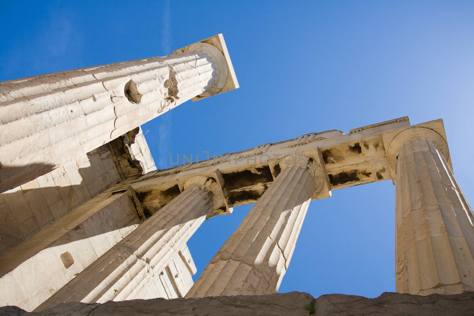 Columns of entrance propylaea to ancient temple Parthenon in Acropolis Athens Greece on blue sky background