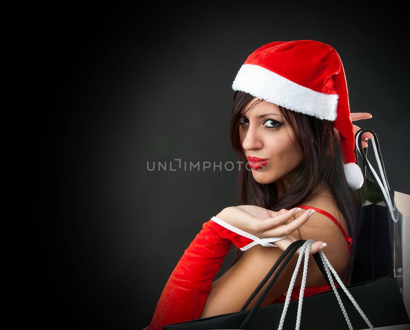 Portrait of Beautiful sexy girl wearing santa claus clothes with shopping bag