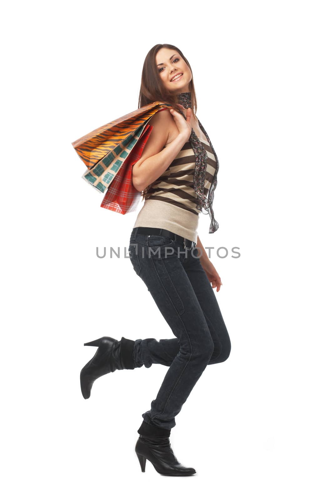 Full length portrait of a young woman with bags over white
