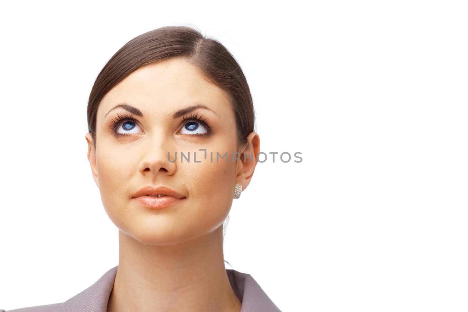 Closeup of a thoughtful young woman looking up over white background 