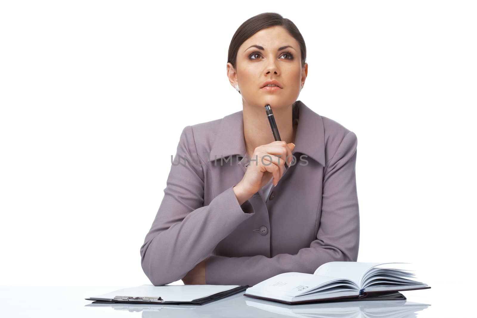 Portrait of a thoughtful young businesswoman with pen and notebook