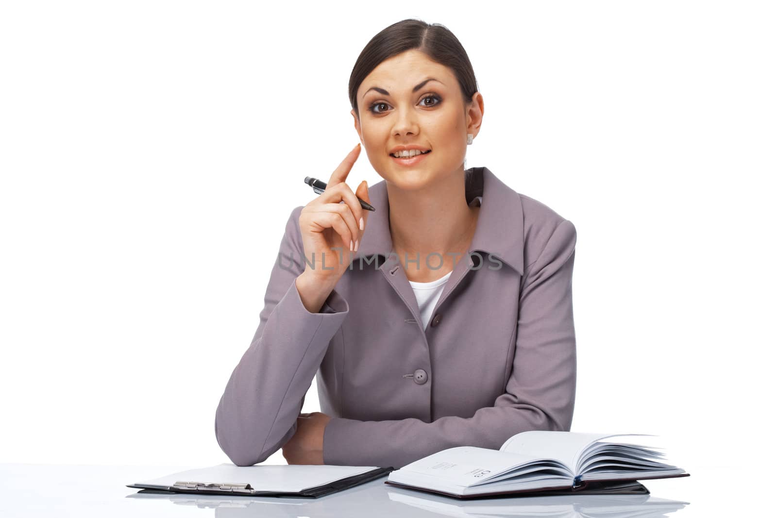 Portrait of a young attentive businesswoman with a pen and dairy over white.