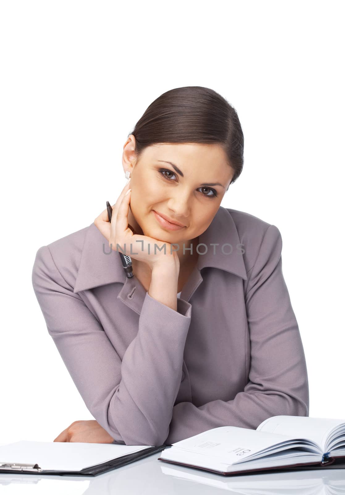 Portrait of a young businesswoman at the desk with her chin on the hand