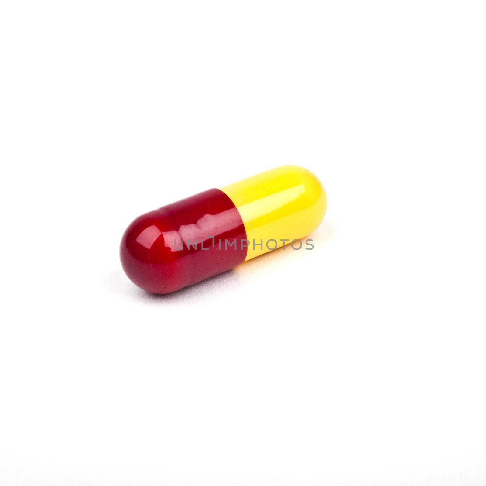 A solitary Pill on a white background.