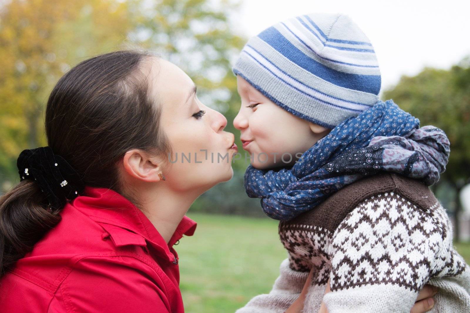 Mother and son kissing in autumn park