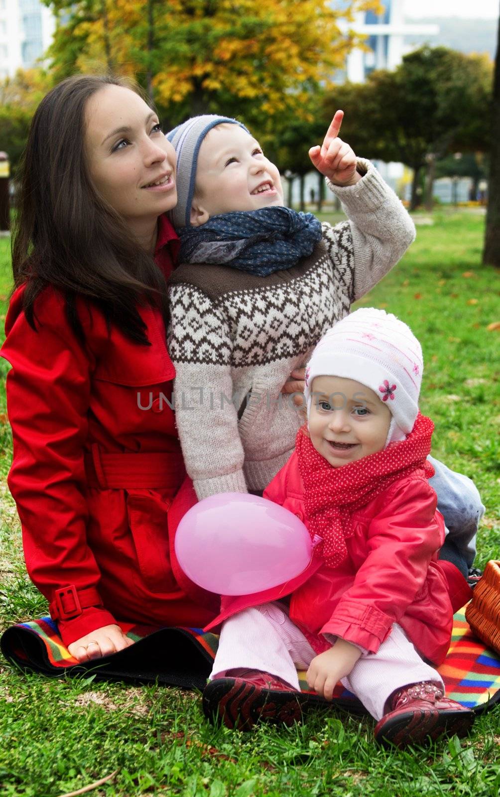 Mother and two lovely children in autumn park