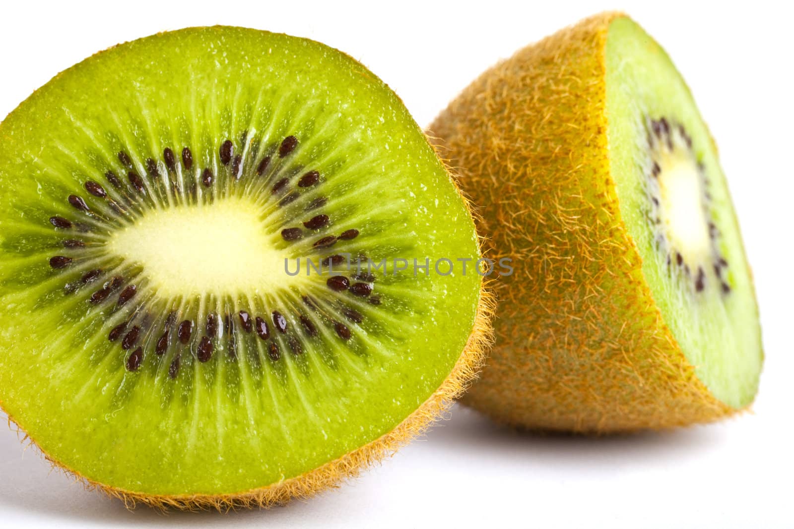 A Kiwi Fruit cut in half over a white background.