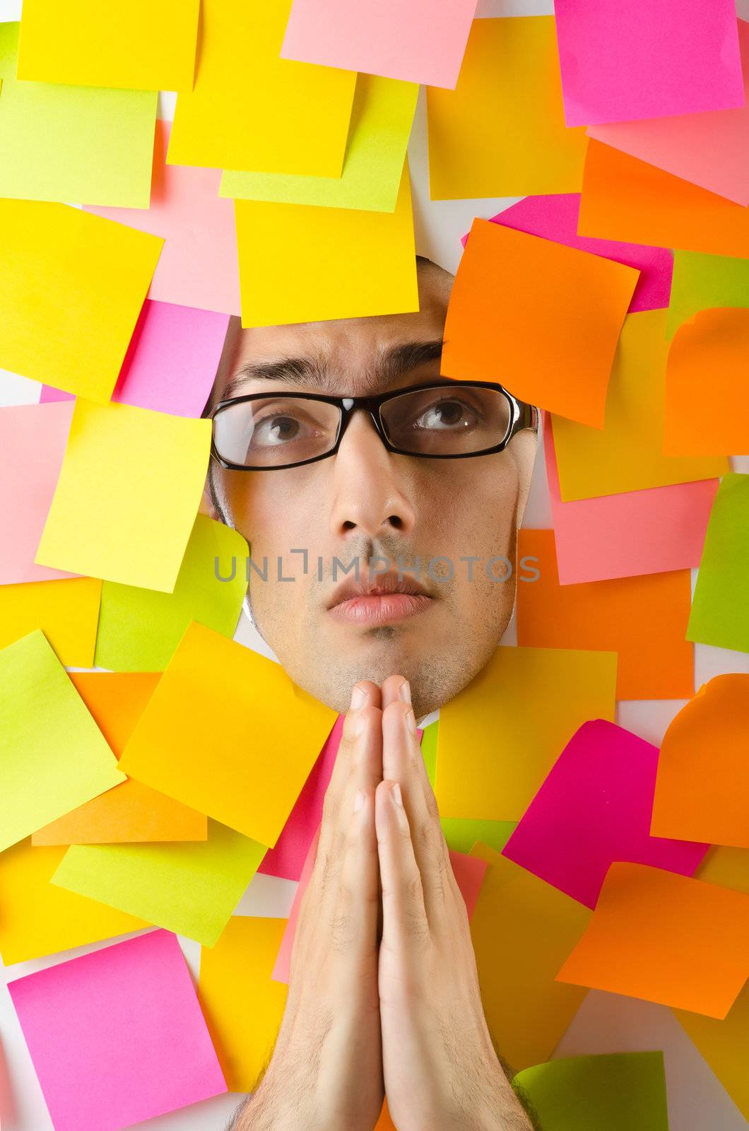 Man's face through paper and reminders