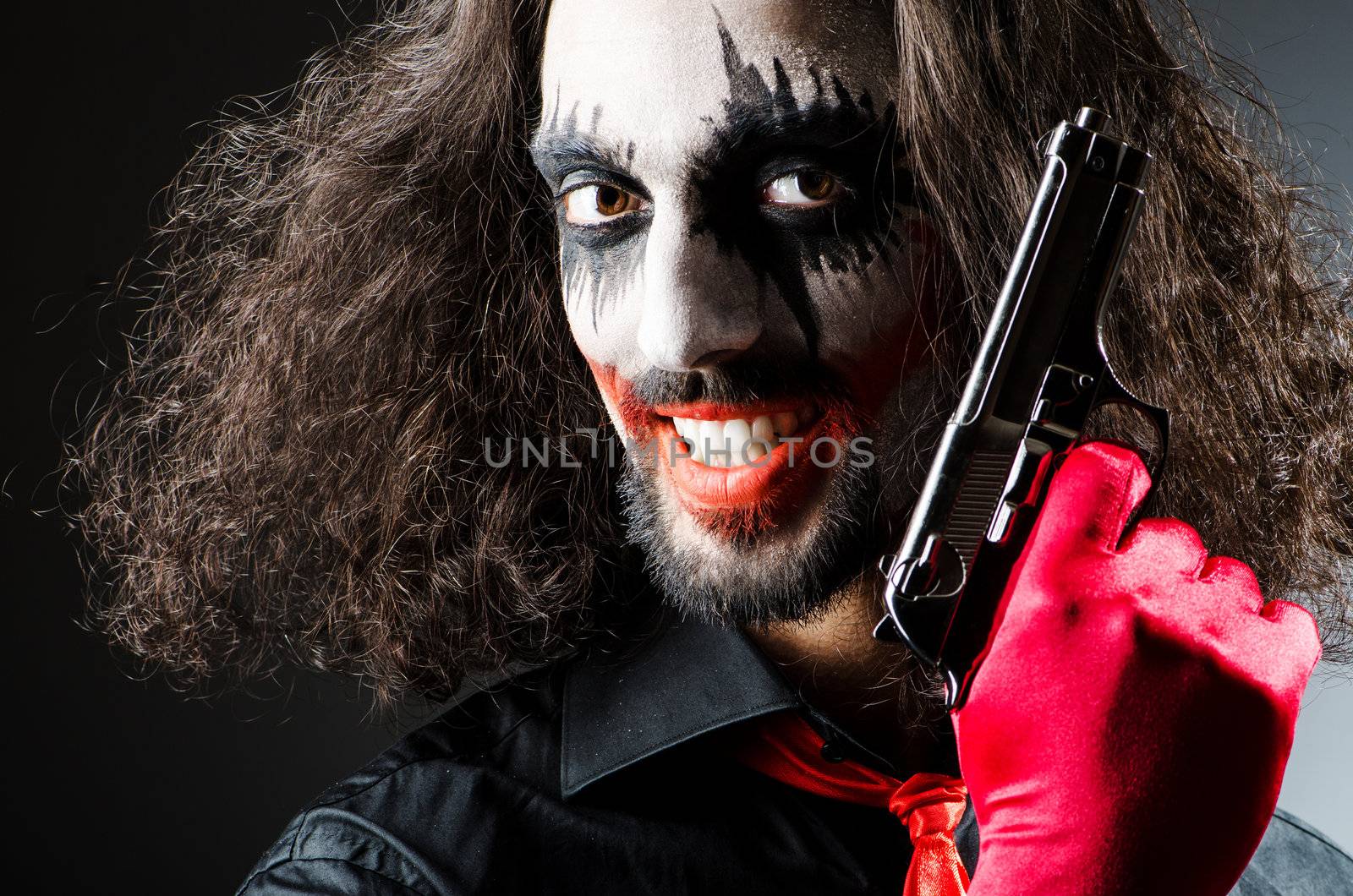 Evil clown with gun in dark room by Elnur