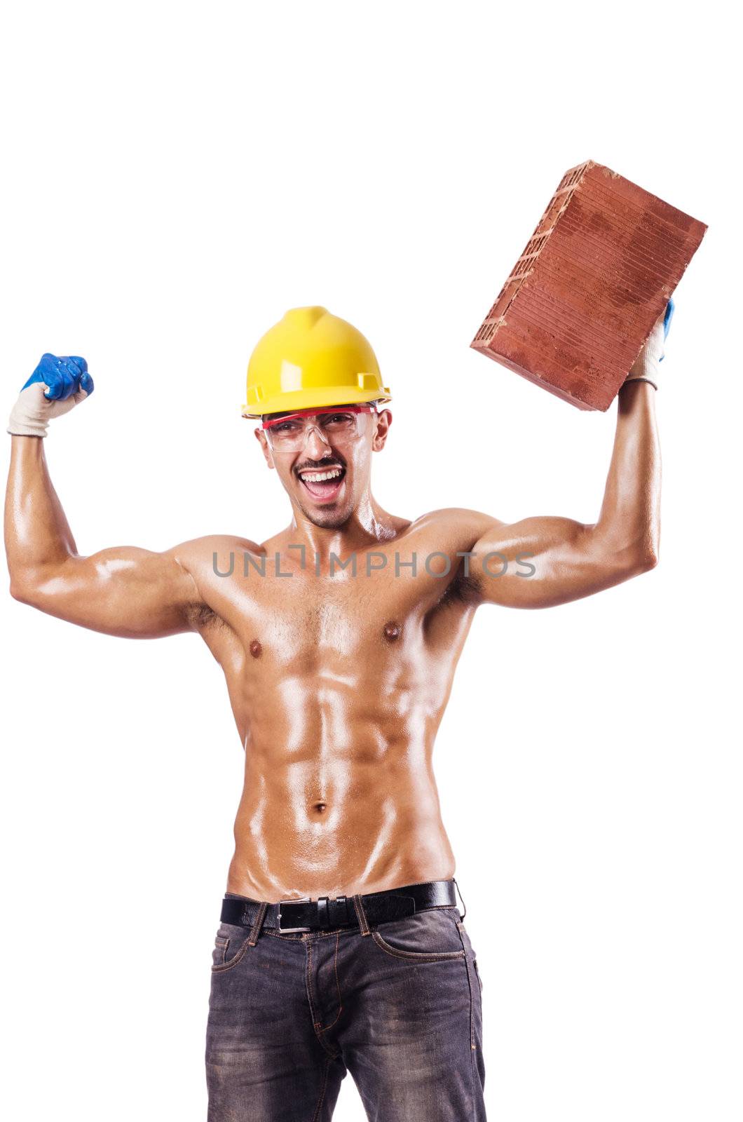 Muscular builder with bricks on white