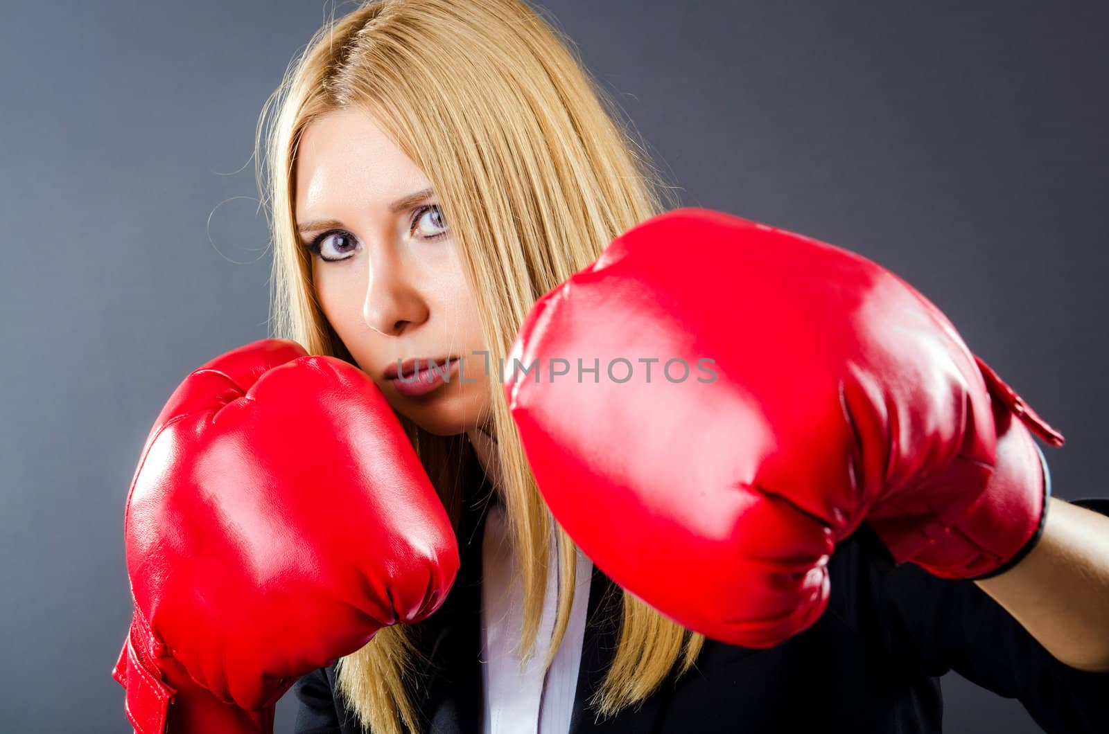 Woman boxer in dark room