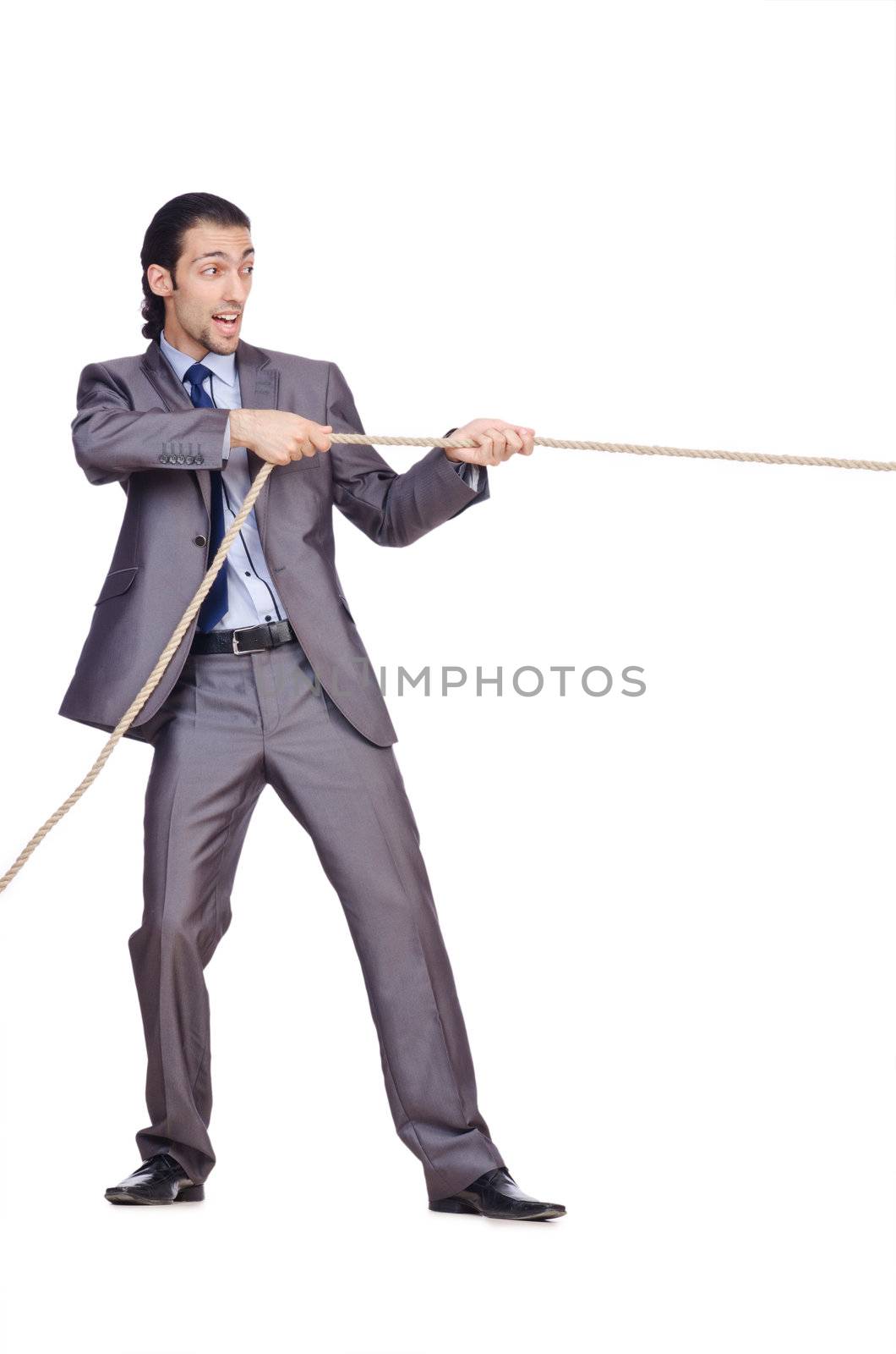 Businessman pulling rope on white