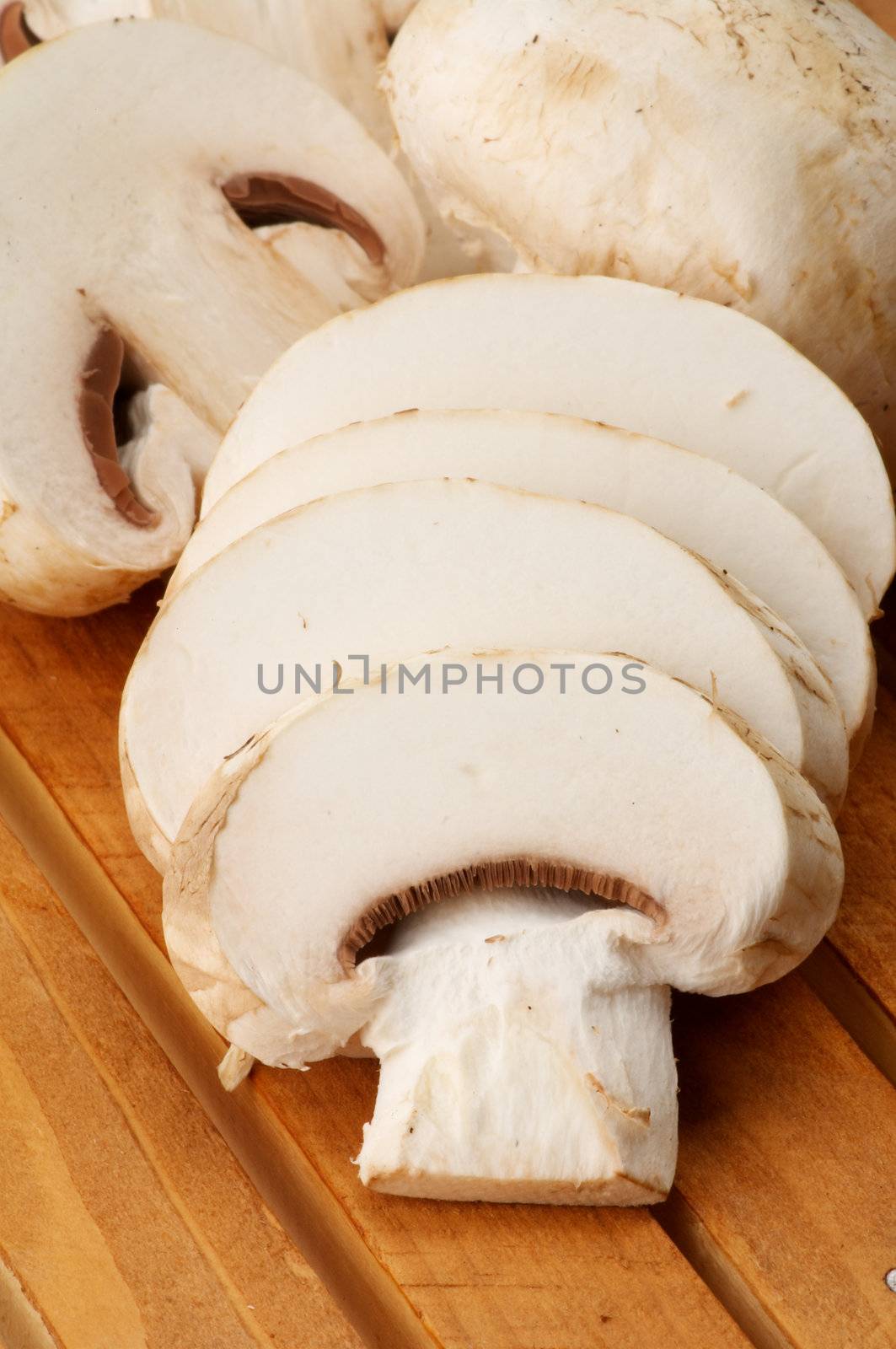 Full Body and Slices of Сhampignon closeup on Wooden background
