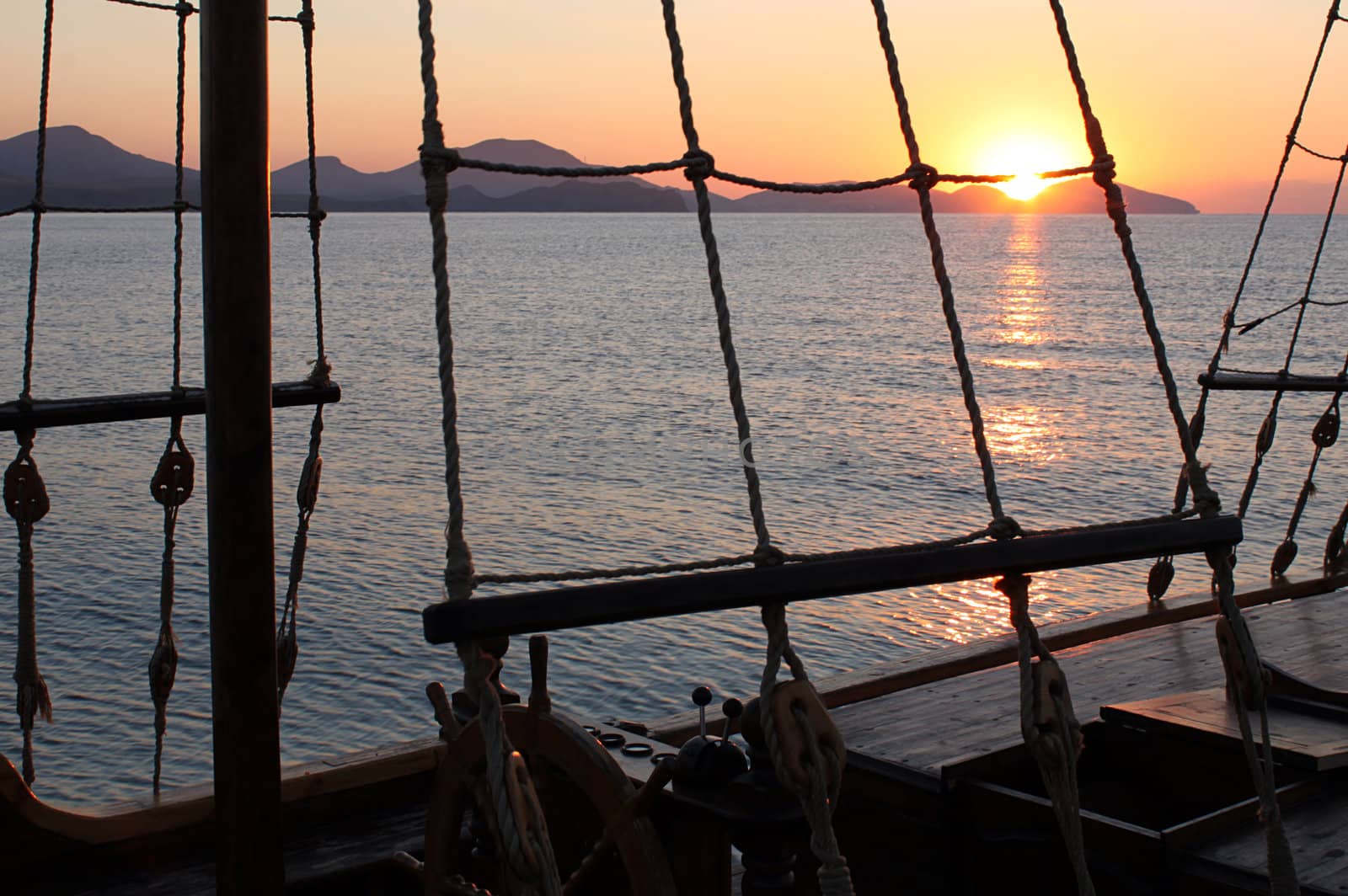 rigging of ship over sunrise