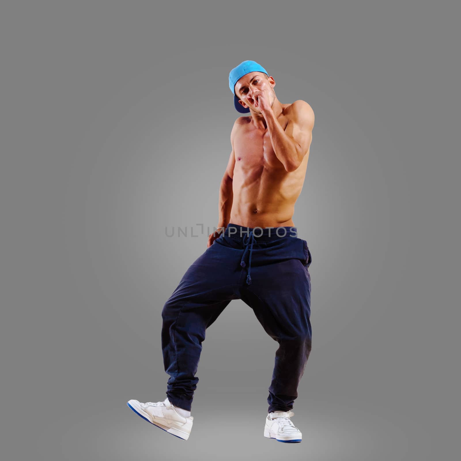 dancer of hip-hop on a gray background , motion