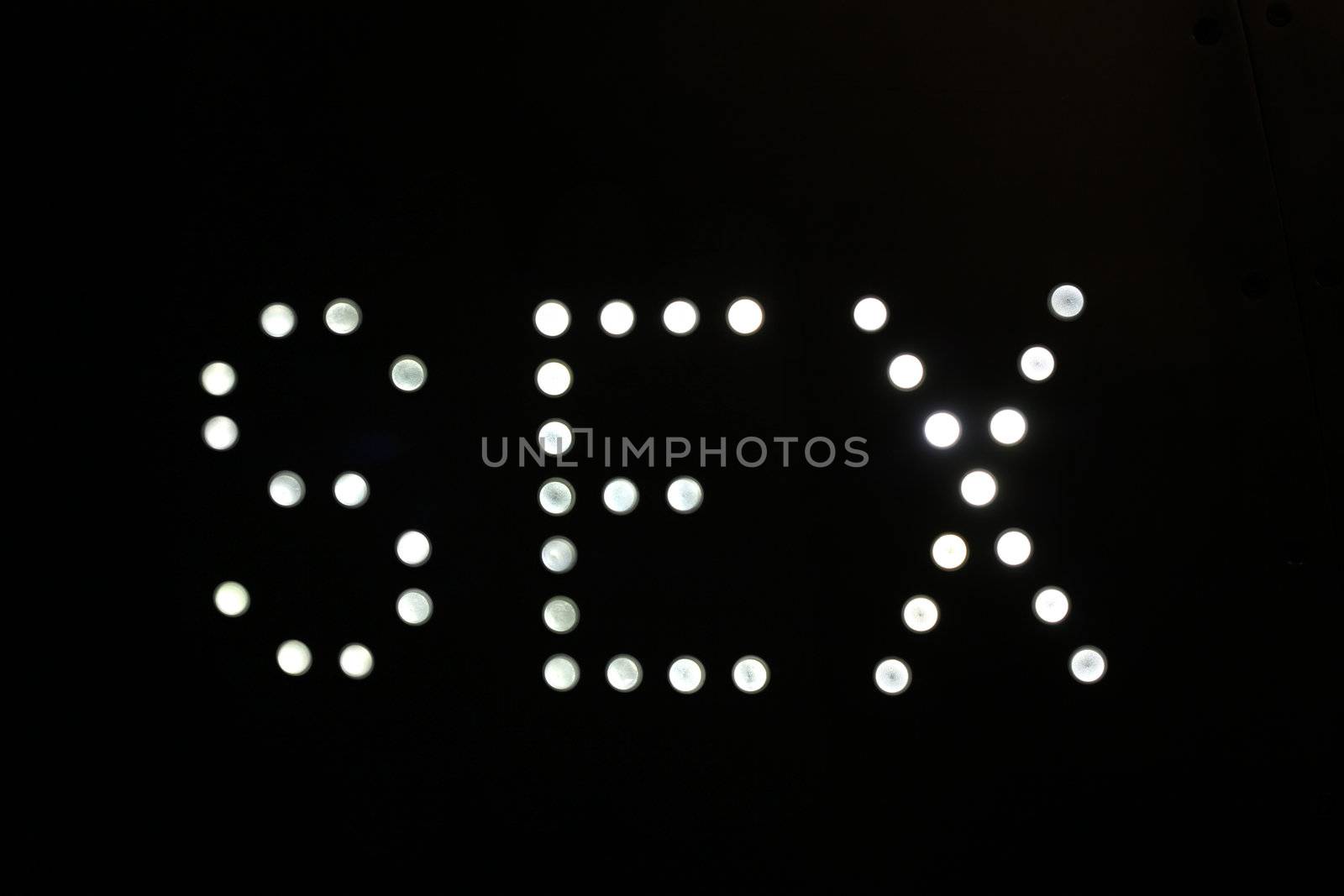 A sign made up of lightbulbs, reading sex