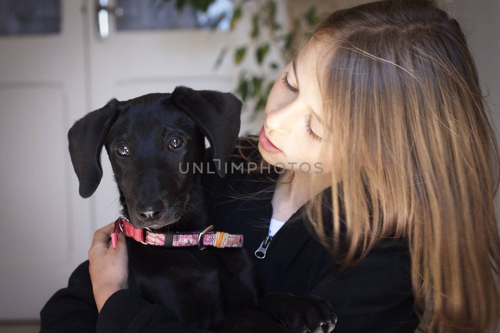 Child with adorable black dog. Soft focus, vignette