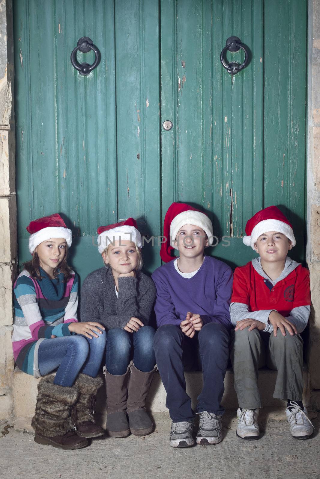 Children dressed in santa hats. Space for text