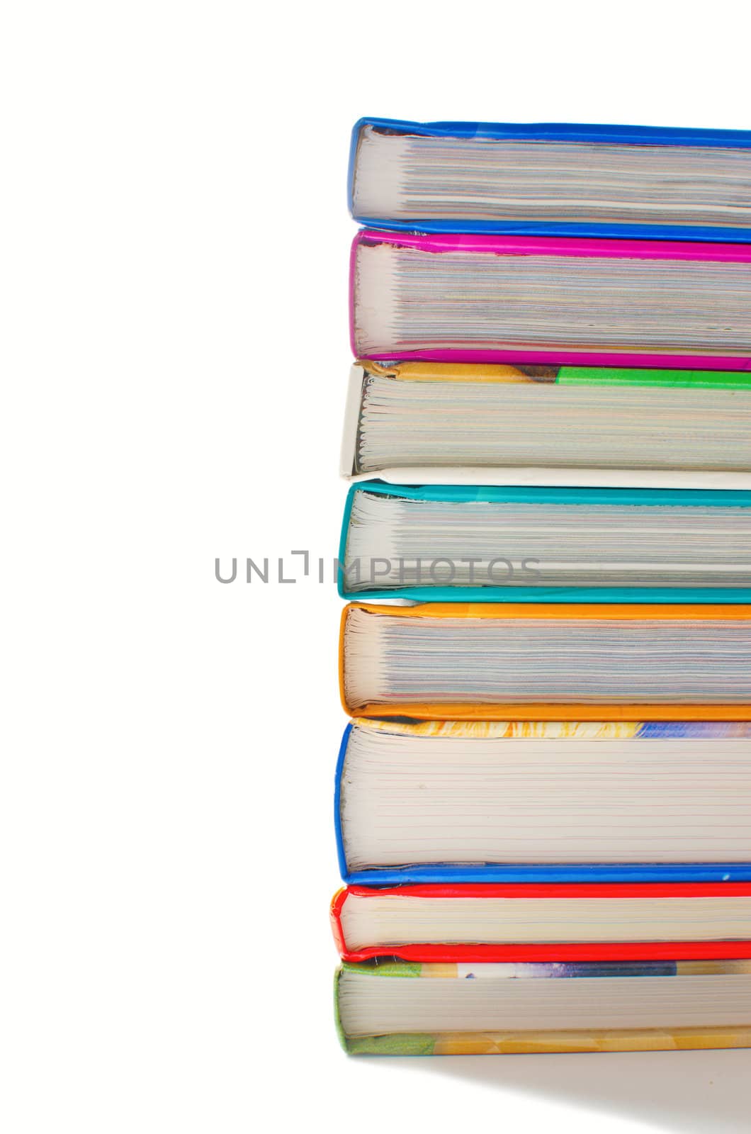 Stack of books in a row on white background by malija