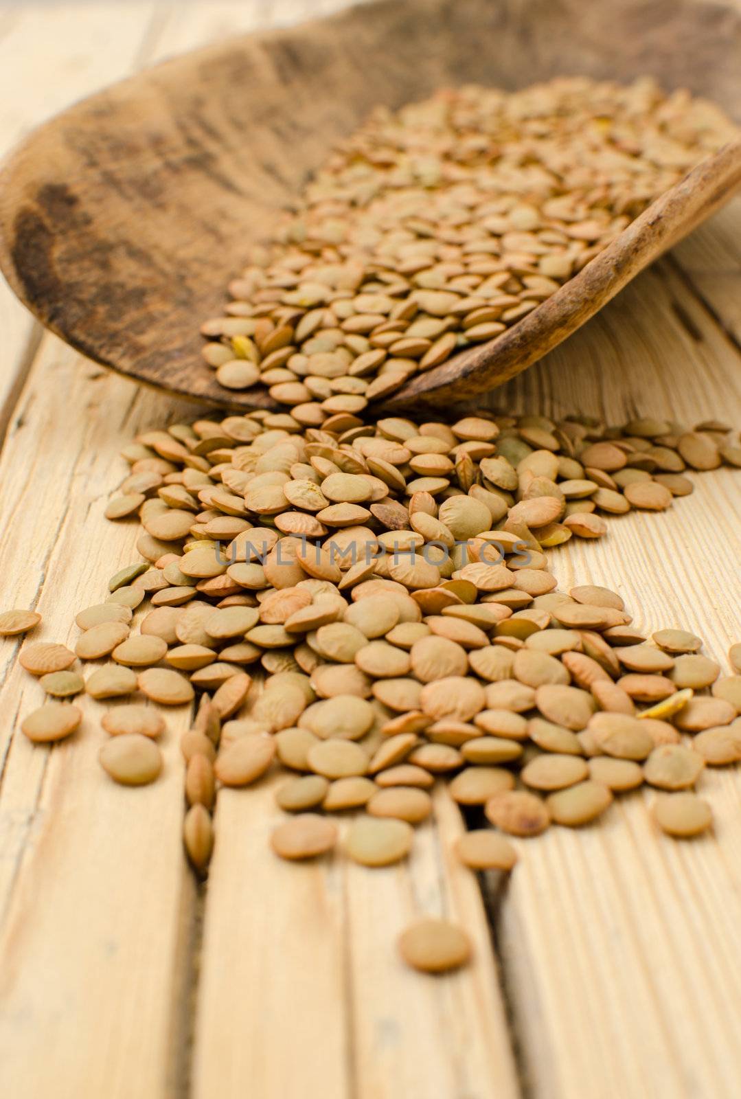 Lentil seeds on a wooden background