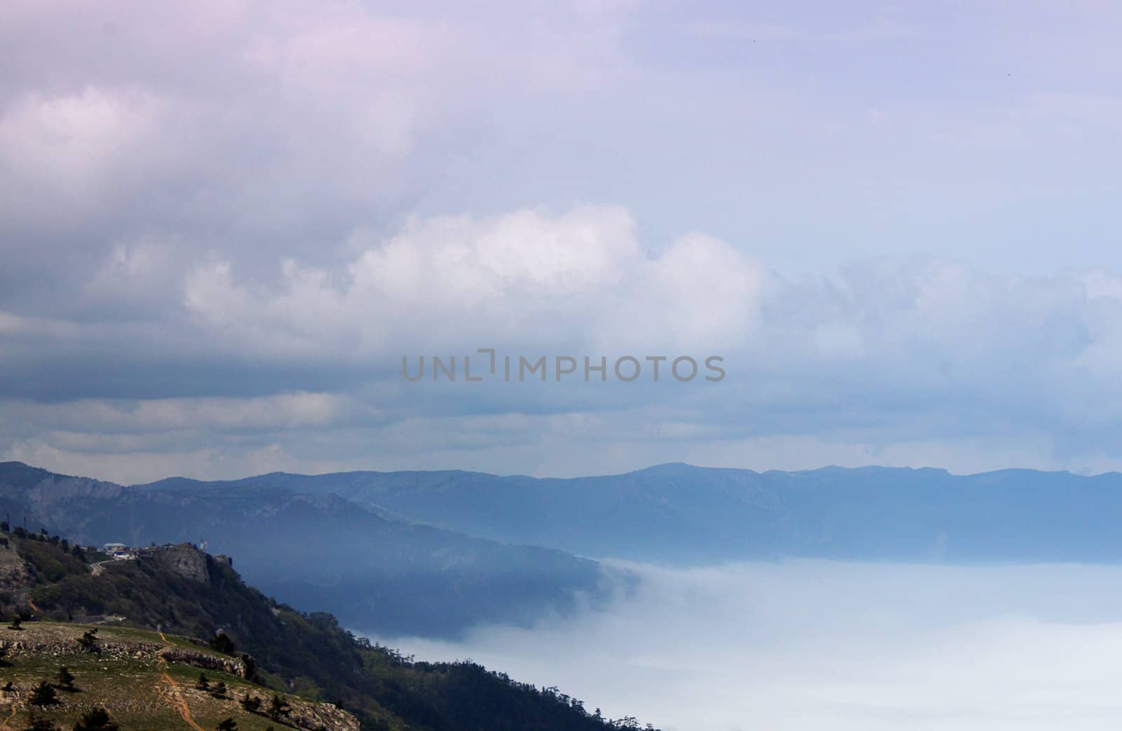 mountains between clouds