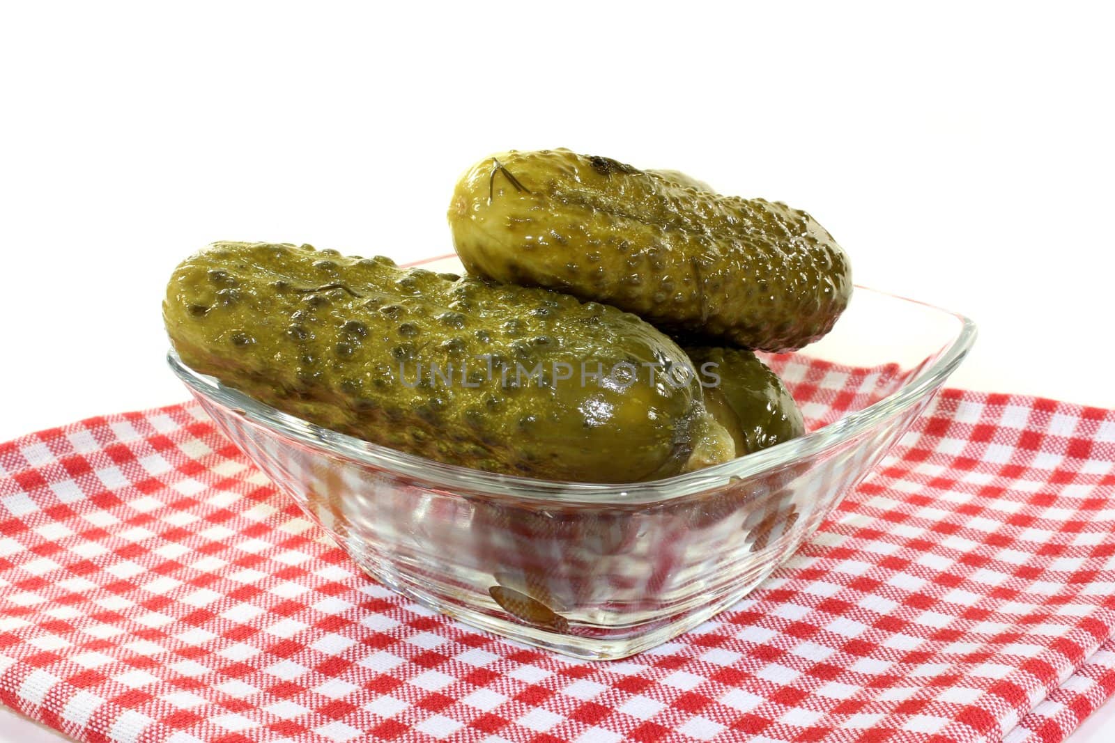 a glass bowl with fresh gherkins