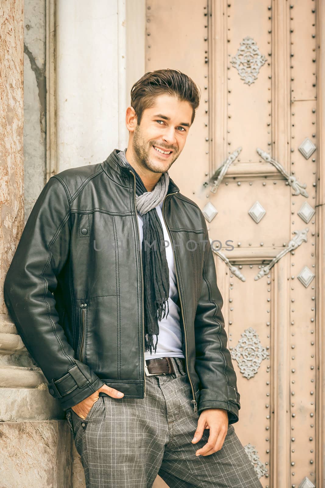 An image of a young man with a black leather jacket