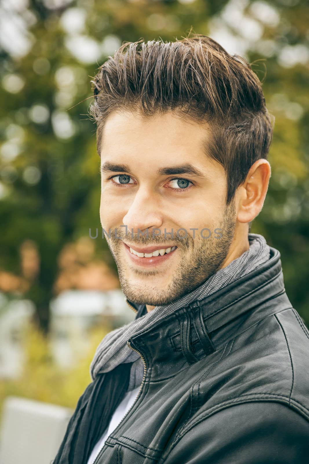 An image of a young man with a black leather jacket