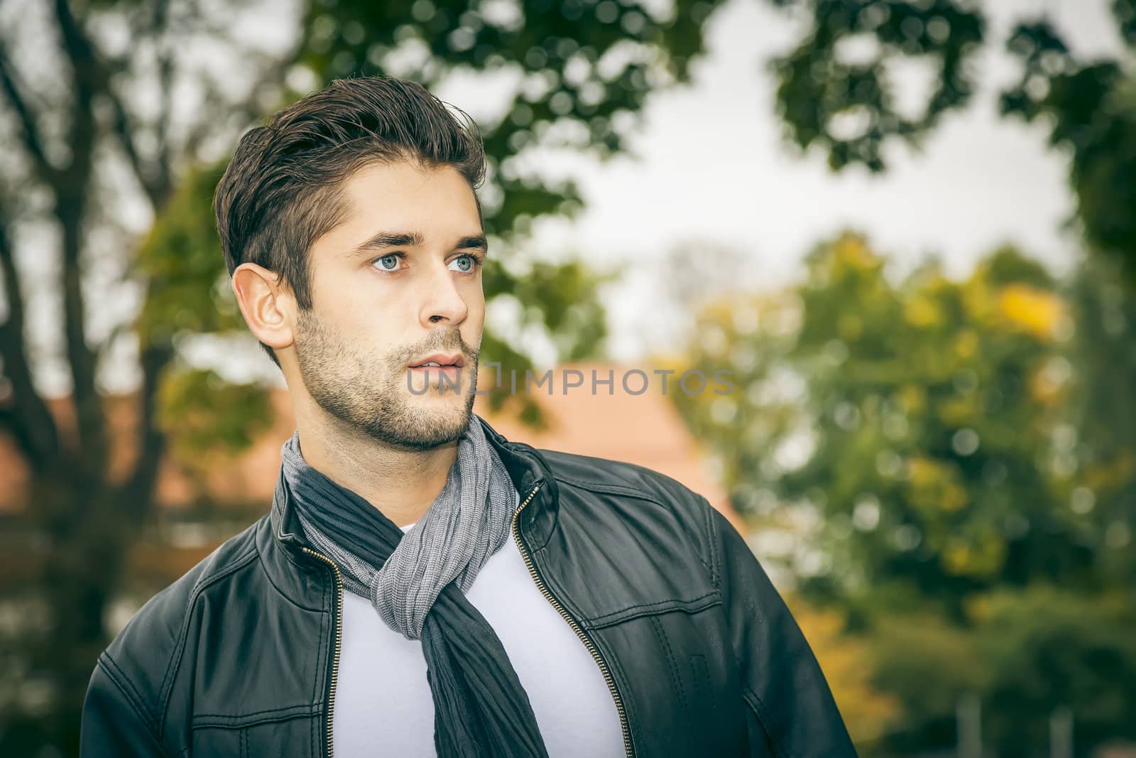 An image of a young man with a black leather jacket