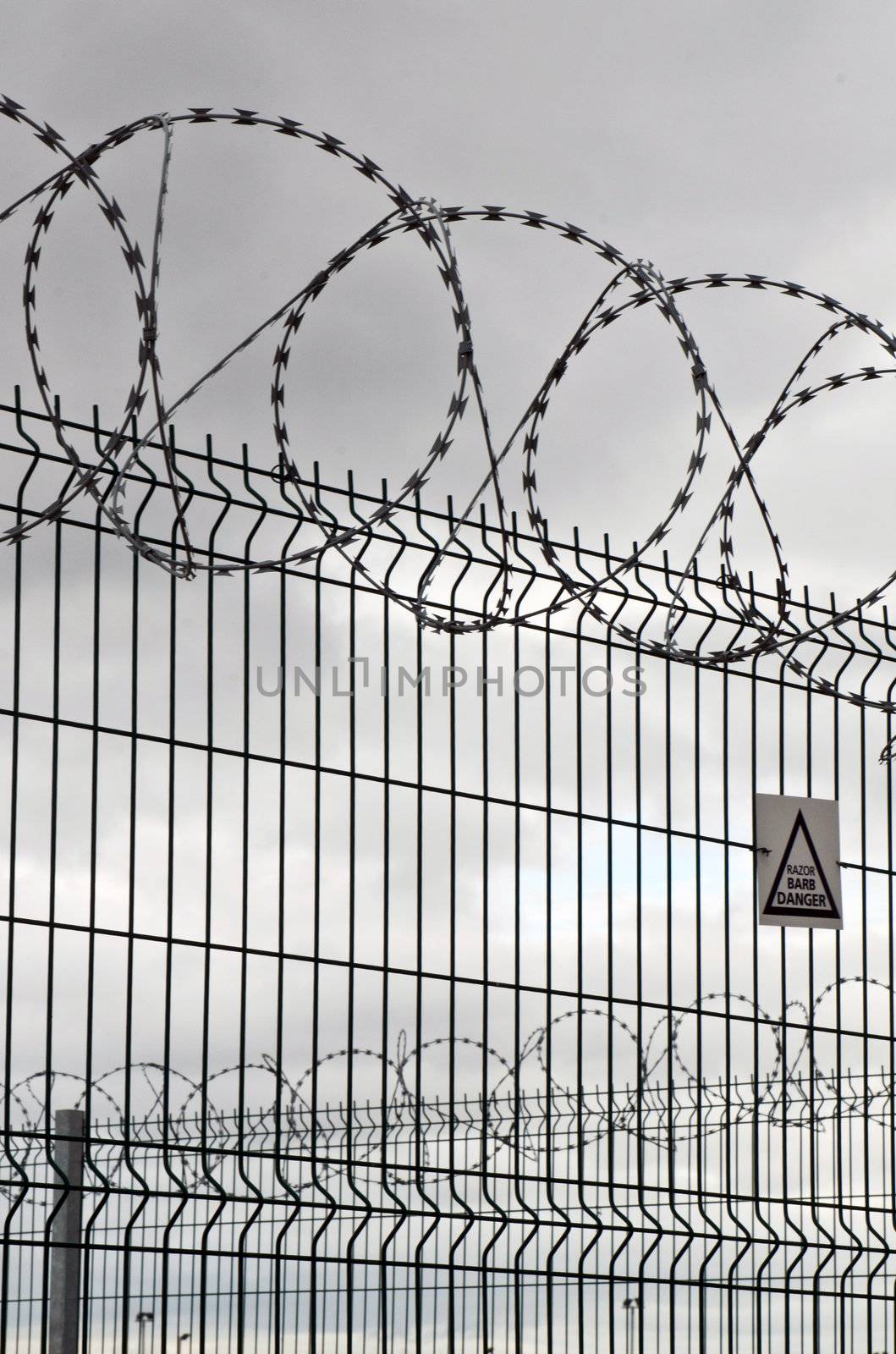 circular barbed wire and fence on a very overcast day