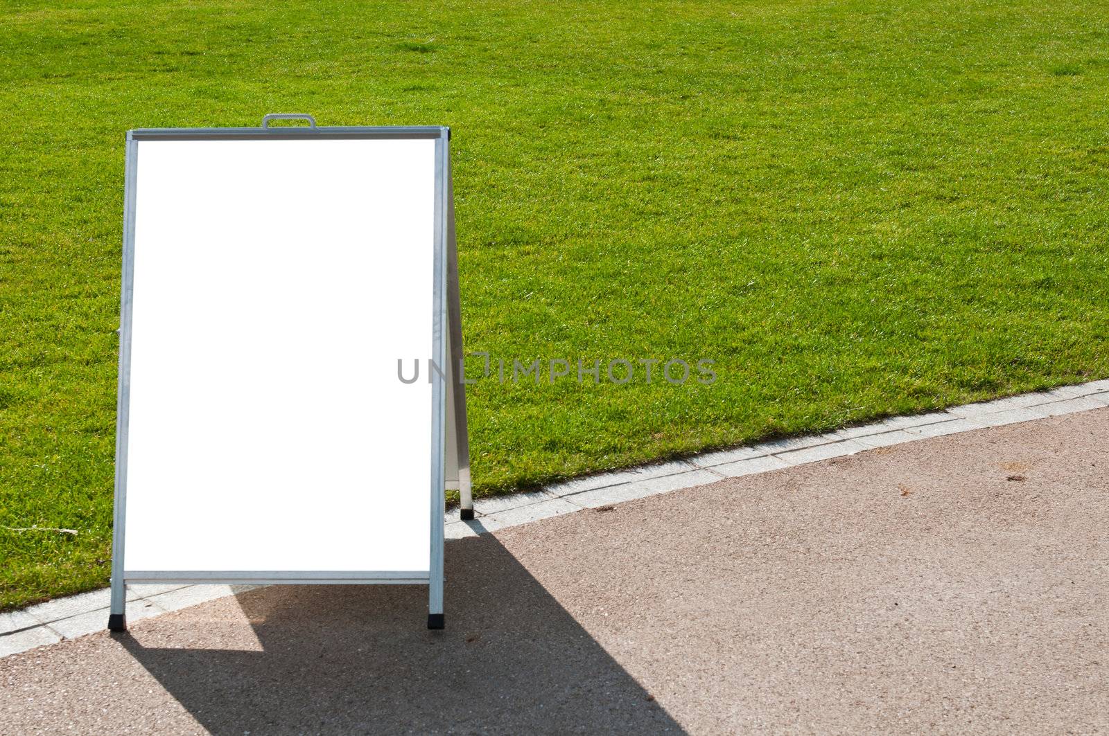 empty metallic board next to a grass field (isolated on white, focus on the grass)